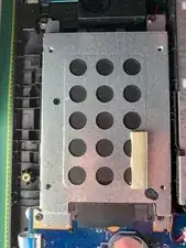 Remove the 4 retaining screws and then slide the unit back away from the connector (the black tab at the bottom of the photograph. It will then come free without bending the pins.