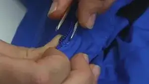 Pinch the zip stop together with the help of the tweezers.