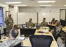 Uniformed personnel at a meeting